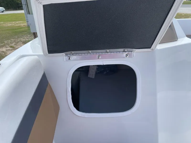 Slide: The Image of Open storage compartment on a 2025 Starcraft SVX-171 boat, showcasing interior space. - 13