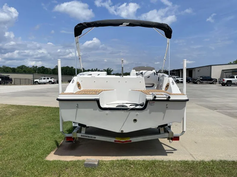 Slide: The Image of 2025 Starcraft SVX-171 boat on trailer, parked outdoors under blue sky. - 4