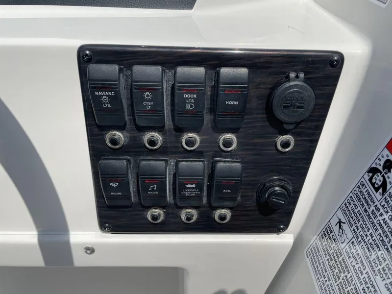 Slide: The Image of Control panel of 2025 Starcraft SVX-171 boat with labeled switches and outlets. - 7