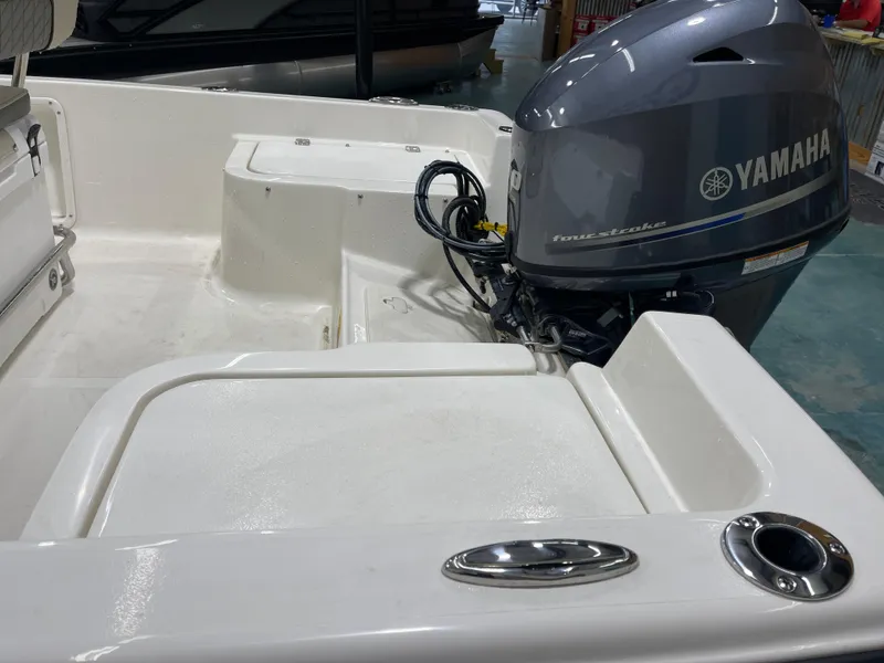 Slide: The Image of 2025 Key West 1720CC boat with Yamaha four-stroke outboard motor in a showroom. - 11