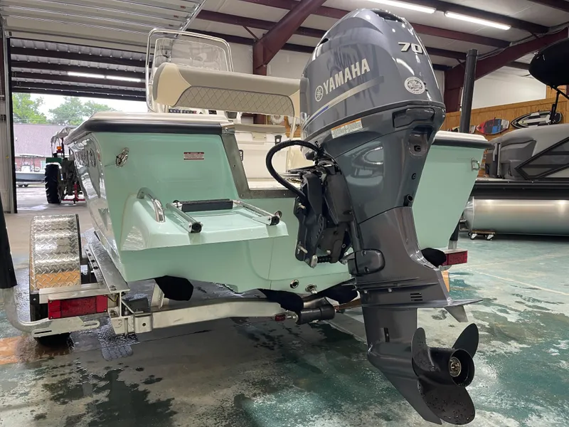 Slide: The Image of 2025 Key West 1720CC boat with Yamaha 70 outboard motor in a garage setting. - 13