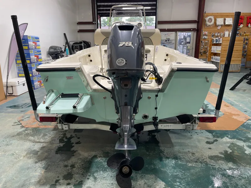 Slide: The Image of 2025 Key West 1720CC boat in showroom, rear view with outboard motor. - 14