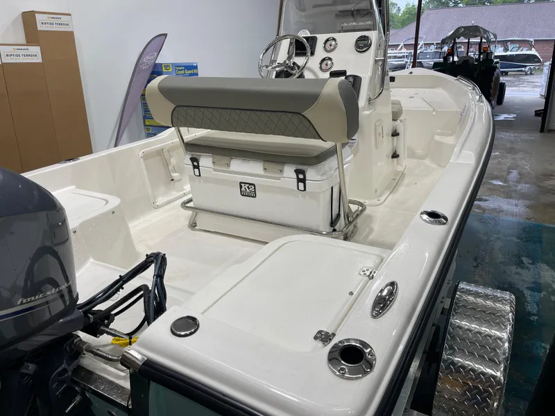 Slide: The Image of 2025 Key West 1720CC boat interior with console and seating in showroom. - 15