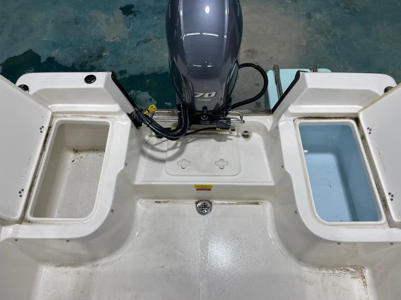 Slide: The Image of 2025 Key West 1720CC boat stern with Yamaha outboard motor and storage compartments. - 17