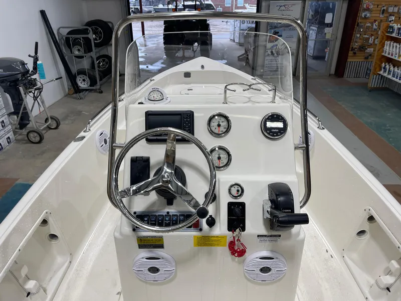 Slide: The Image of 2025 Key West 1720CC boat dashboard with steering wheel and gauges in showroom. - 18