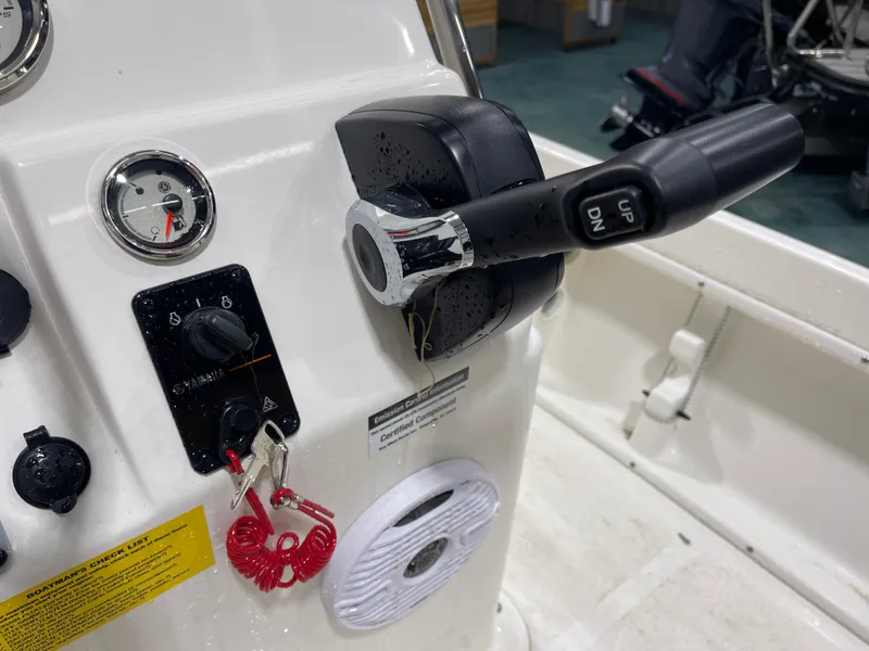 Slide: The Image of 2025 Key West 1720CC boat control panel with throttle and ignition keys. - 21