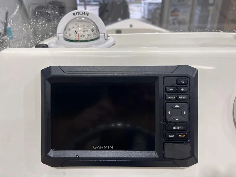 Slide: The Image of Garmin navigation system and Ritchie compass on 2025 Key West 1720CC boat dashboard. - 24