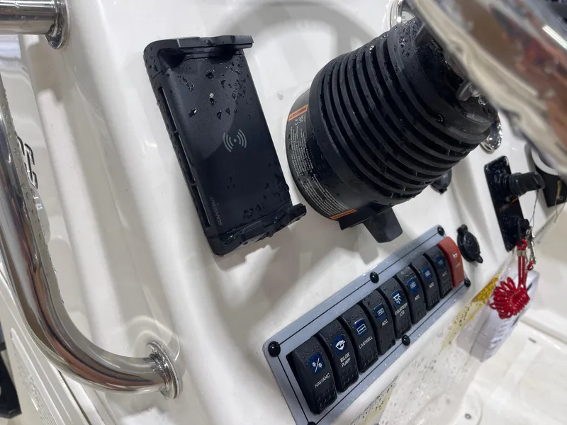 Slide: The Image of Control panel of 2025 Key West 1720CC boat with switches and phone holder. - 25