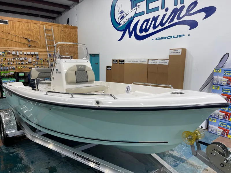 Slide: The Image of 2025 Key West 1720CC boat displayed indoors at a marine store. - 3