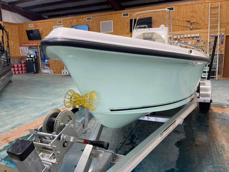Slide: The Image of 2025 Key West 1720CC boat on trailer in showroom setting. - 6