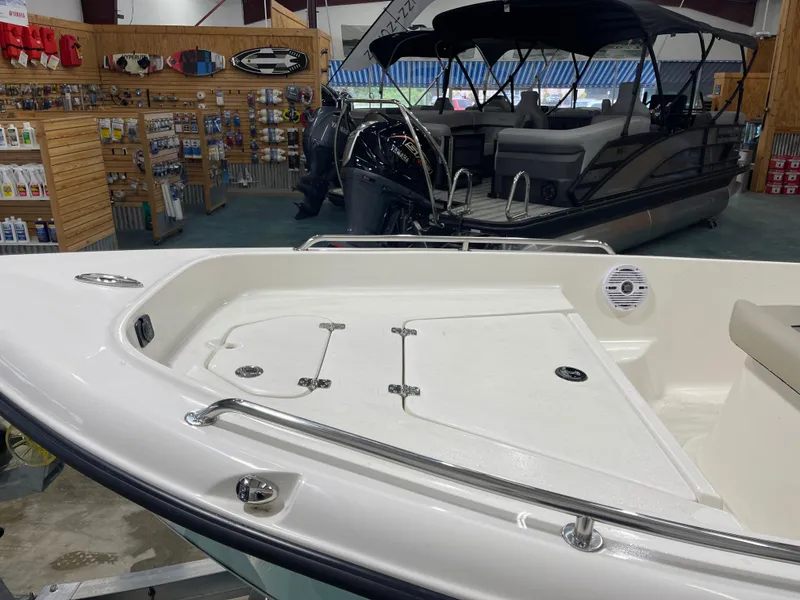 Slide: The Image of 2025 Key West 1720CC boat displayed in a showroom with accessories and equipment. - 8