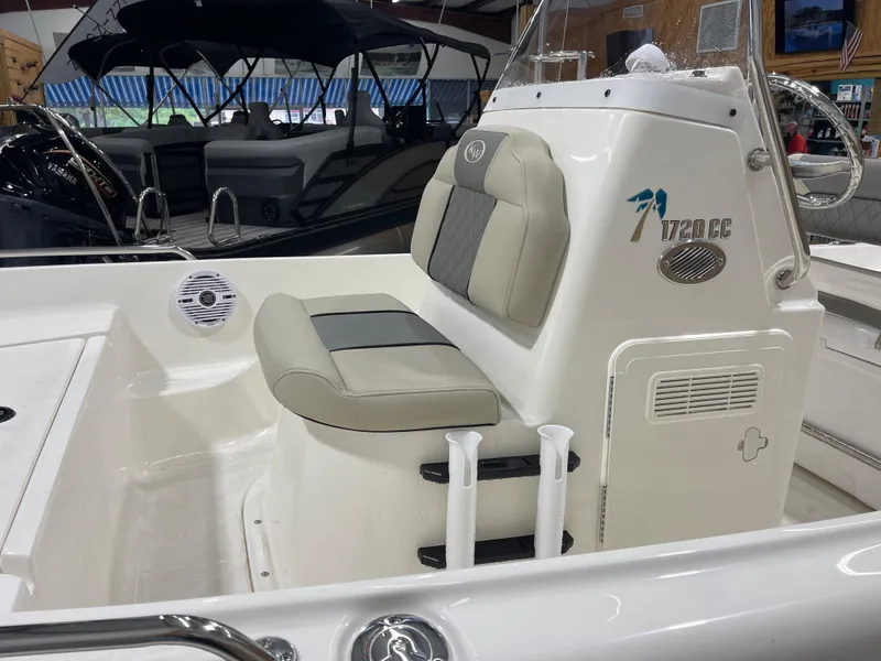 Slide: The Image of 2025 Key West 1720CC boat interior with cushioned seating and console details. - 9