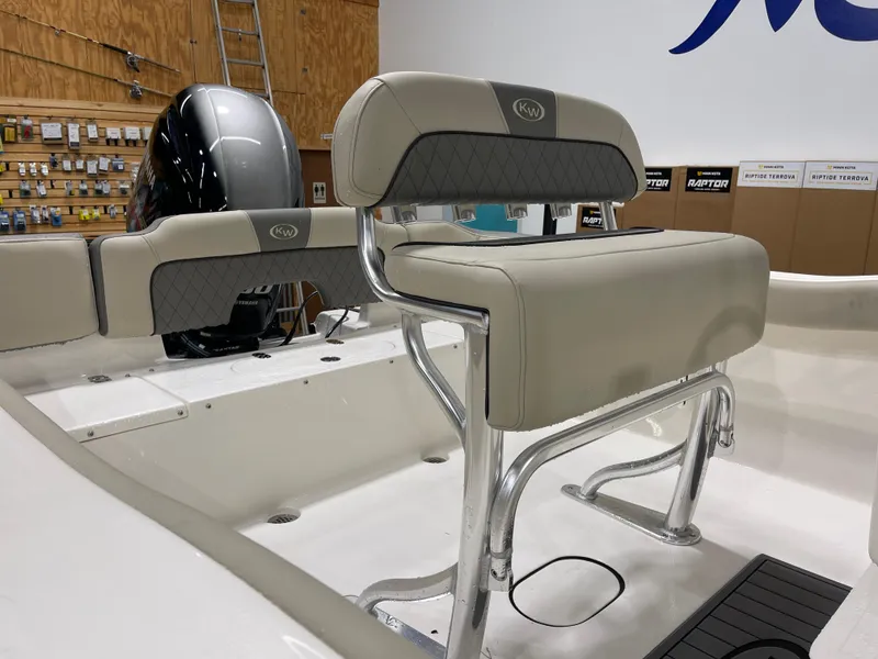 Slide: The Image of 2025 Key West 203FS boat interior with cushioned seating and sleek design. - 12