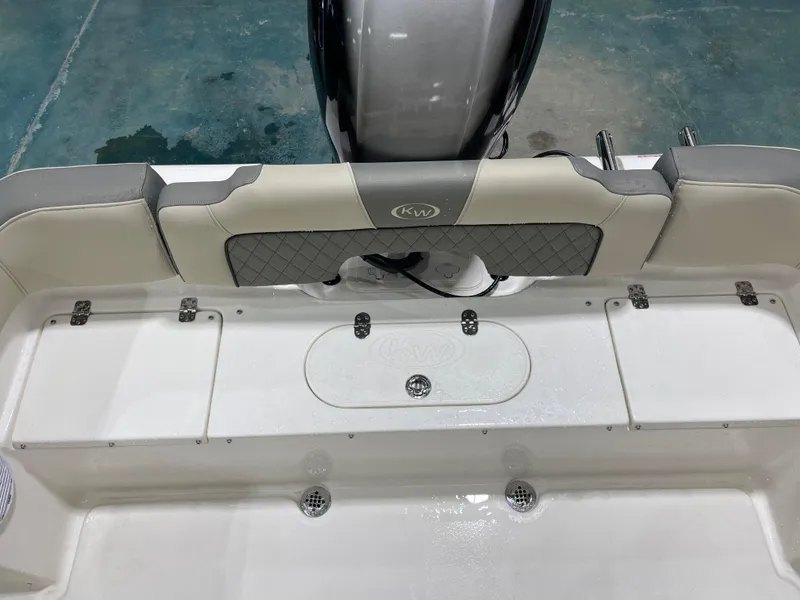 Slide: The Image of 2025 Key West 203FS boat interior with cushioned seating and storage compartments. - 17