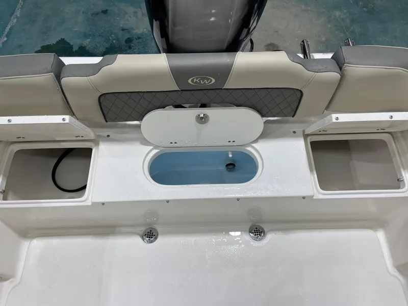 Slide: The Image of 2025 Key West 203FS boat interior with storage compartments and seating. - 18