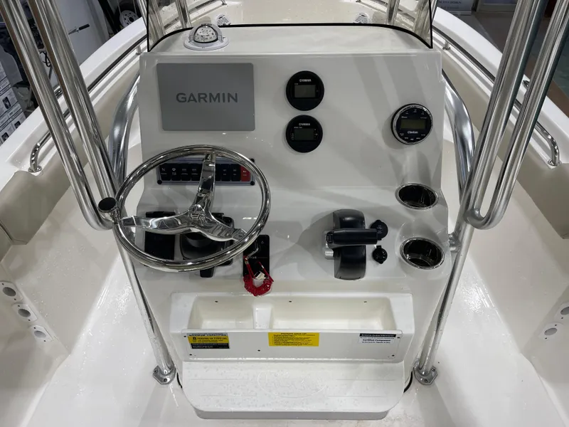 Slide: The Image of 2025 Key West 203FS boat console with Garmin display and steering wheel. - 19