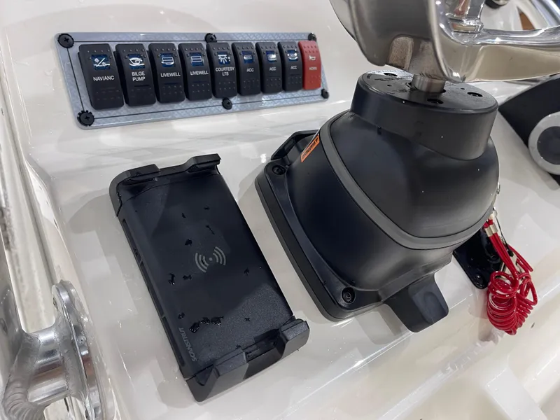 Slide: The Image of Control panel of 2025 Key West 203FS boat with switches and wireless charging pad. - 20