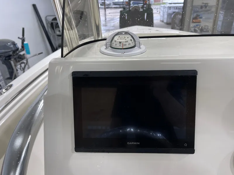 Slide: The Image of 2025 Key West 203FS boat dashboard with Garmin display and compass. - 21