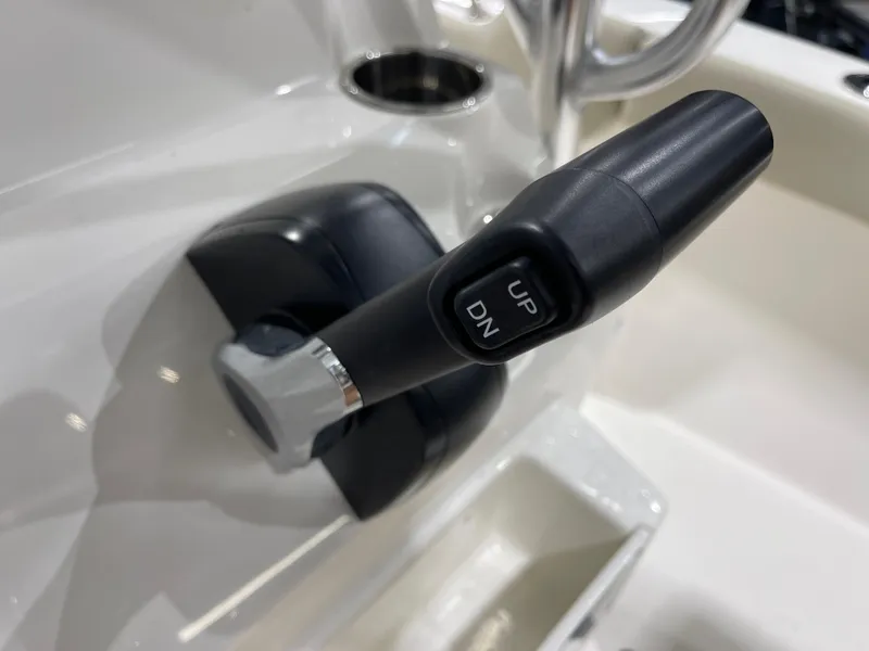 Slide: The Image of Close-up of a 2025 Key West 203FS boat control lever with "UP" and "DN" buttons. - 23