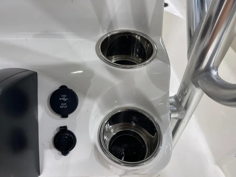 Slide: The Image of 2025 Key West 203FS boat console with cup holders and USB/AUX input. - 24
