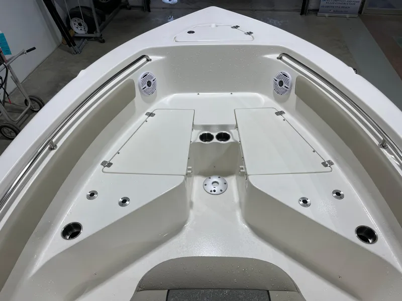 Slide: The Image of 2025 Key West 203FS boat interior with seating, cup holders, and speakers. - 28