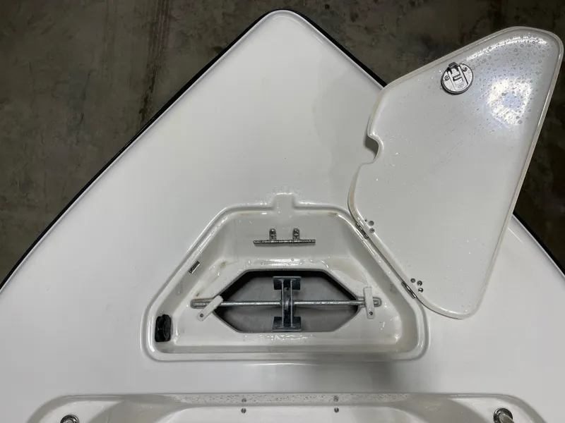 Slide: The Image of 2025 Key West 203FS boat anchor compartment with open hatch, showcasing storage details. - 31
