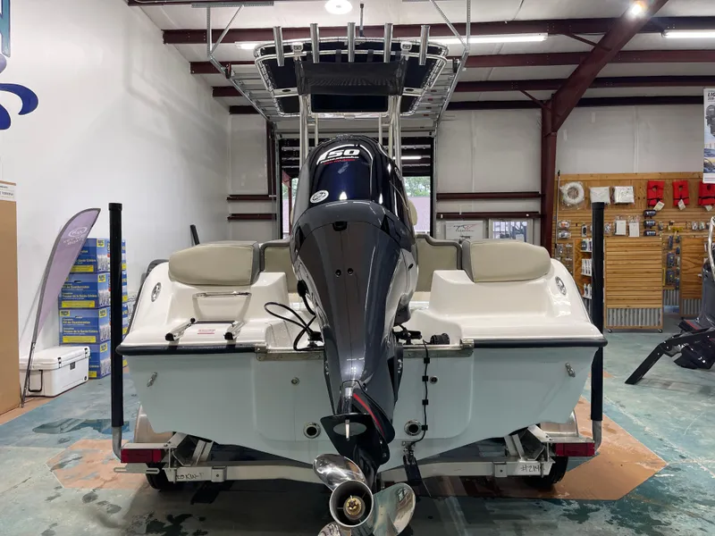 Slide: The Image of 2025 Key West 203FS boat with powerful engine in a showroom setting. - 9