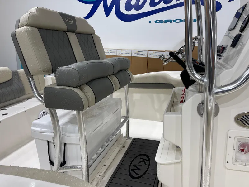 Slide: The Image of 2025 Key West 219fs boat interior with cushioned seating and console. - 11