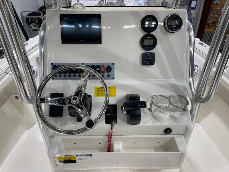 Slide: The Image of 2025 Key West 219fs boat console with steering wheel, gauges, and controls. - 13