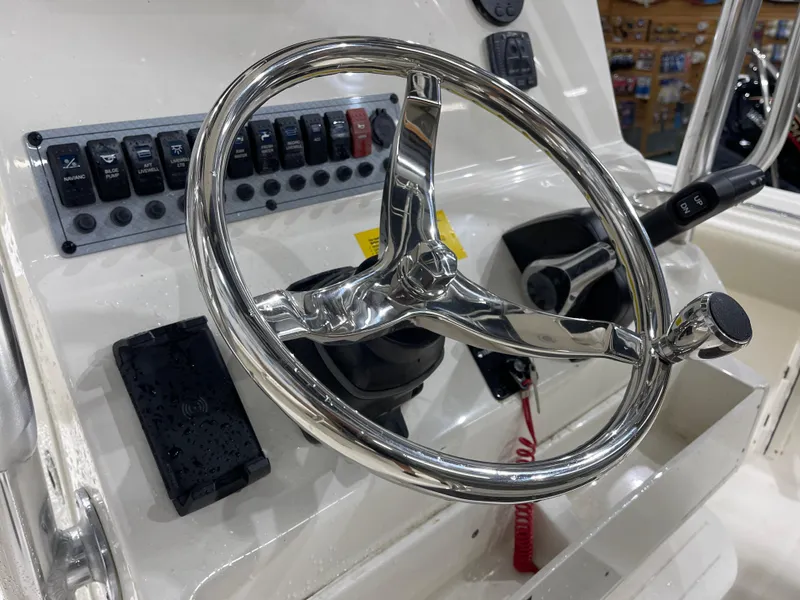 Slide: The Image of Steering wheel and controls of 2025 Key West 219fs boat. - 14
