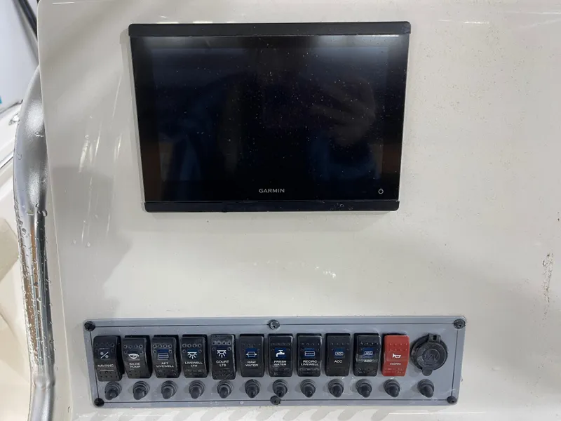 Slide: The Image of Control panel of a 2025 Key West 219fs boat with Garmin display and switches. - 15