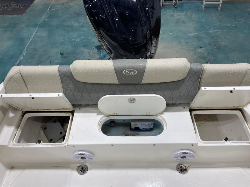 Slide: The Image of 2025 Key West 219fs boat interior with cushioned seating and storage compartments. - 18
