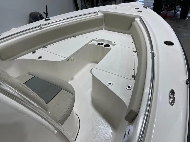 Slide: The Image of 2025 Key West 219fs boat interior with cushioned seating and cup holders. - 21