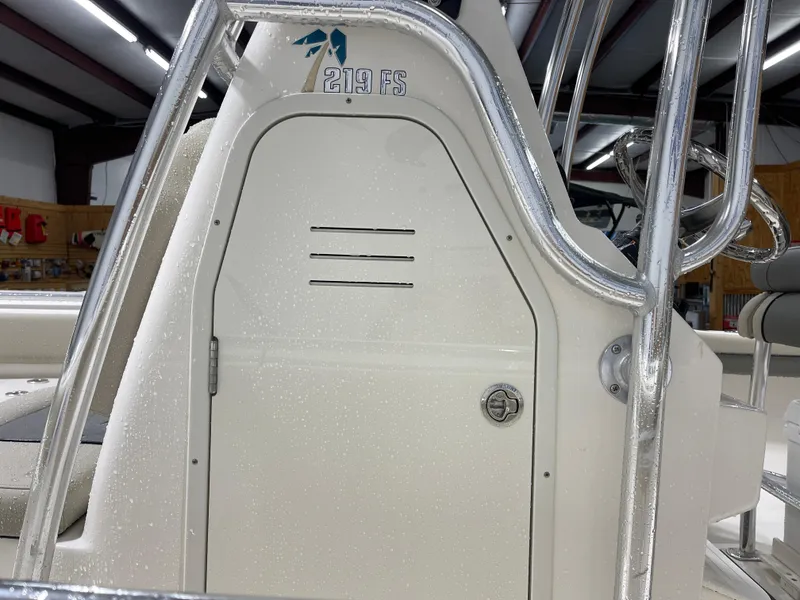 Slide: The Image of 2025 Key West 219fs boat console with stainless steel railings in a showroom. - 6