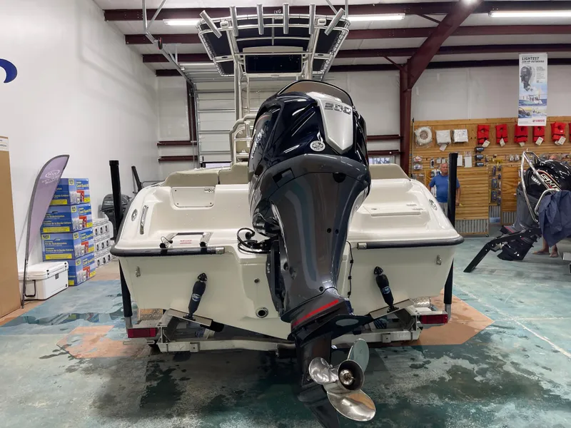 Slide: The Image of 2025 Key West 219fs boat with outboard motor in a showroom. - 8