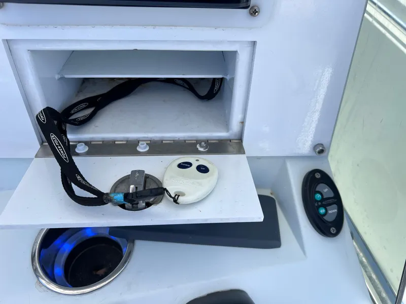 Slide: The Image of Control panel and storage compartment on a 2003 Contender 21 Open boat. - 18