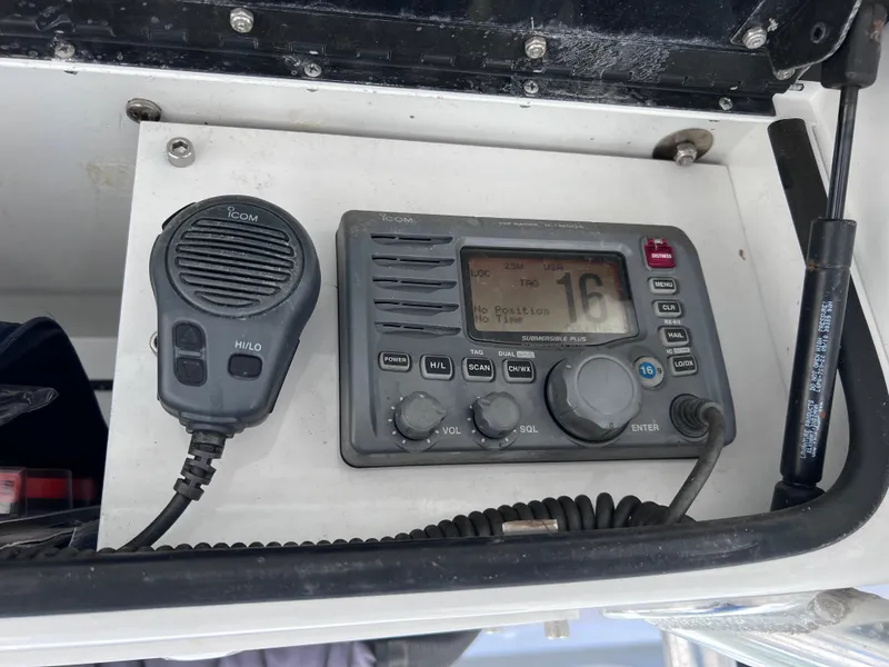 Slide: The Image of VHF marine radio and microphone on Contender 21 Open boat dashboard. - 21