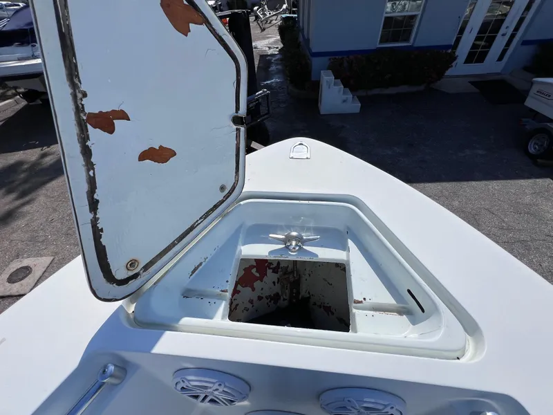 Slide: The Image of Open storage compartment on 2003 Contender 21 Open boat, showing wear and rust. - 32