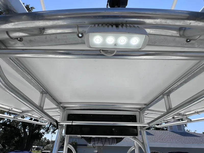 Slide: The Image of T-top of 2003 Contender 21 Open boat with LED lights, showcasing sturdy aluminum frame. - 41