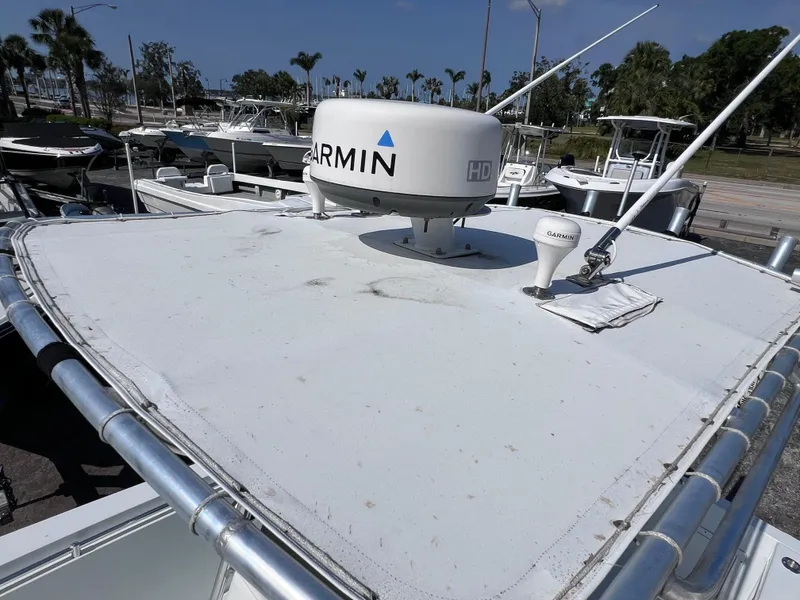 Slide: The Image of Contender 21 Open boat with Garmin radar, docked, featuring 2014 Yamaha 250 engine. - 43