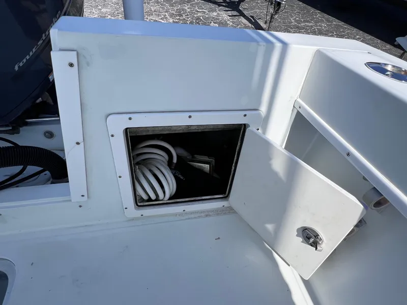 Slide: The Image of Open storage compartment on 2003 Contender 21 Open boat with coiled hose inside. - 44