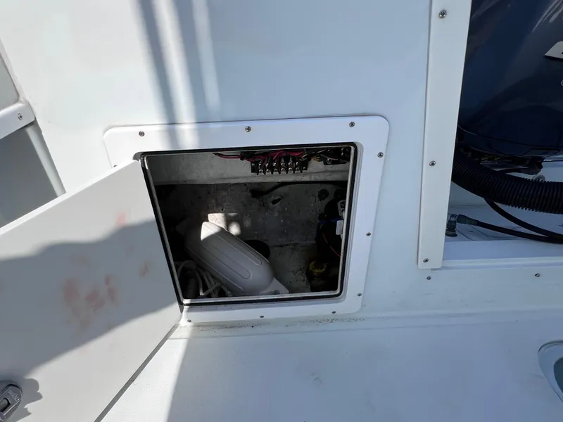 Slide: The Image of Open compartment on 2003 Contender 21 Open boat, showing interior wiring and components. - 45