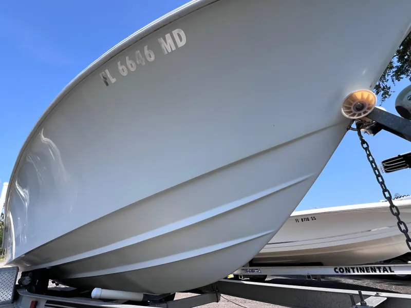 Slide: The Image of 2003 Contender 21 Open boat on trailer, featuring 2014 Yamaha 250 engine. - 6