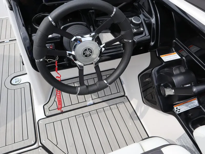 Slide: The Image of Steering wheel and controls of 2021 Yamaha Boats 212, featuring sleek design and modern technology. - 14