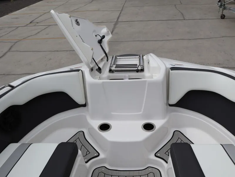 Slide: The Image of 2021 Yamaha Boats 212 interior with open storage compartment and seating. - 19