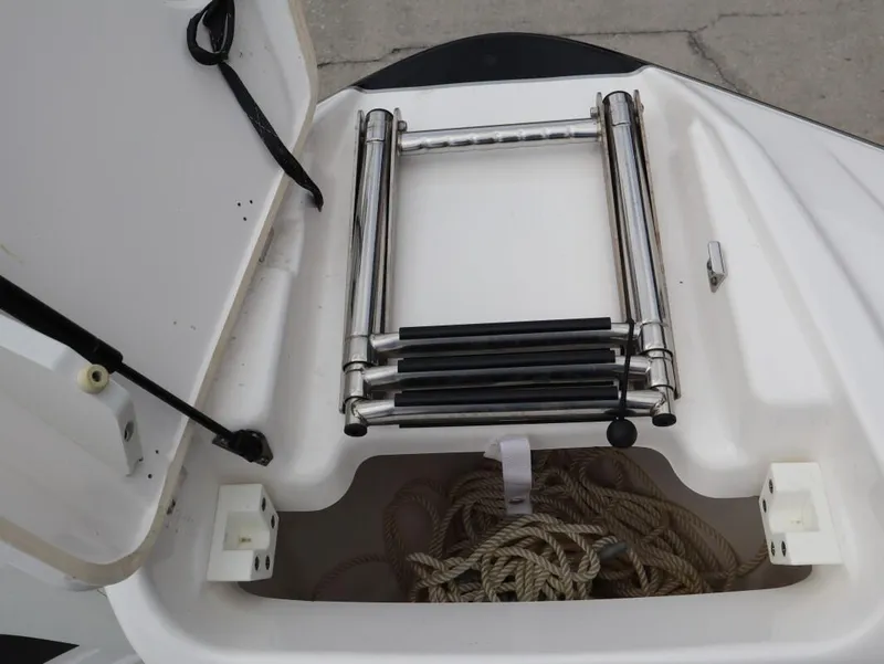 Slide: The Image of Yamaha Boats 212 (2021) storage compartment with ladder and rope. - 20