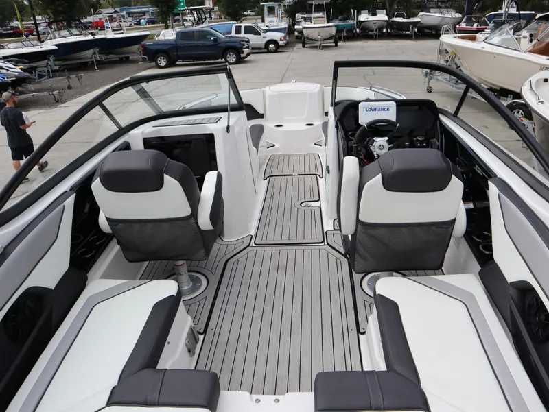 Slide: The Image of 2021 Yamaha Boats 212 interior with sleek seating and modern dashboard. - 8