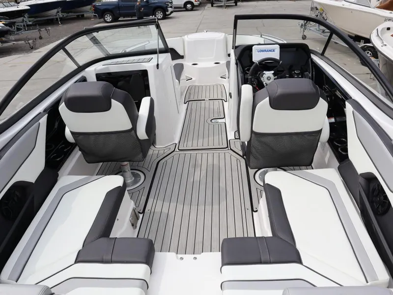Slide: The Image of Interior view of 2021 Yamaha Boats 212, featuring sleek seating and modern dashboard. - 9