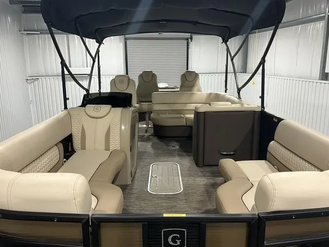 Slide: The Image of 2022 Godfrey Monaco 235 FS pontoon boat interior with beige seating and canopy. - 10