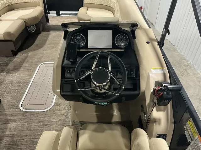 Slide: The Image of 2022 Godfrey Monaco 235 FS boat interior with steering wheel and dashboard controls. - 11
